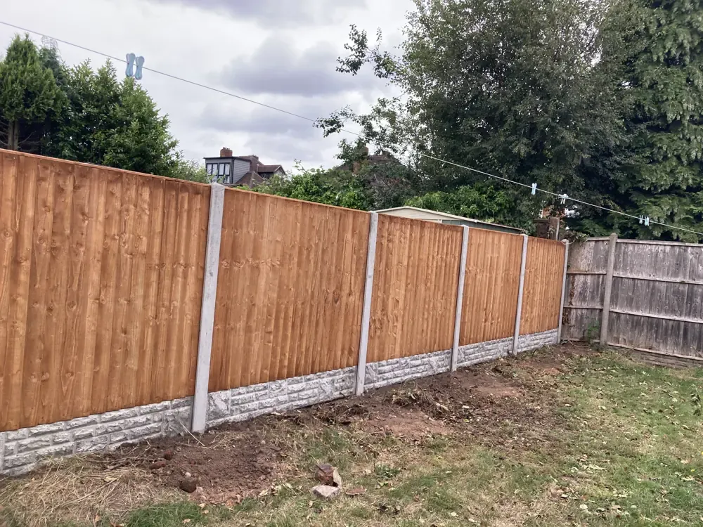 Close-board fence on concrete posts with concrete gravel boards