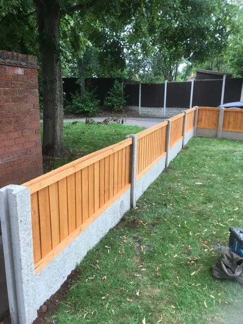 Low close-board front garden fence on concrete posts