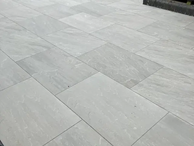 Grey porcelain patio slabs laid with tight, even joints