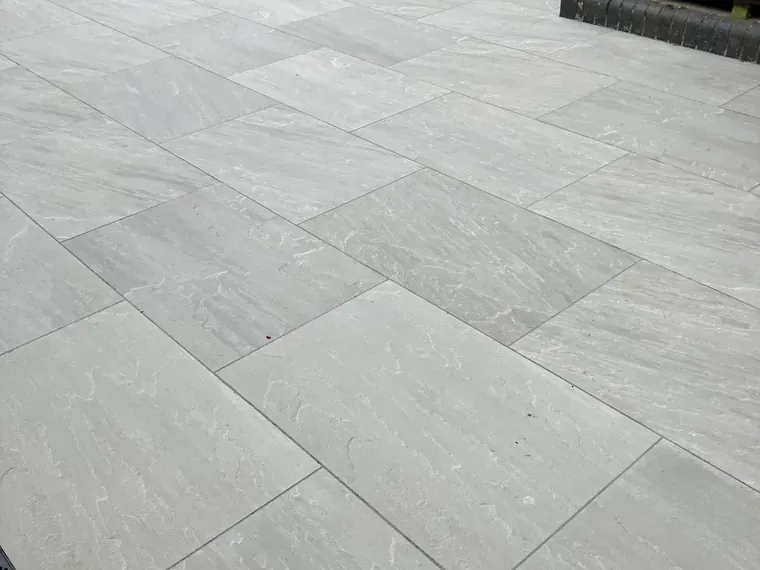 Grey porcelain patio slabs laid with tight, even joints