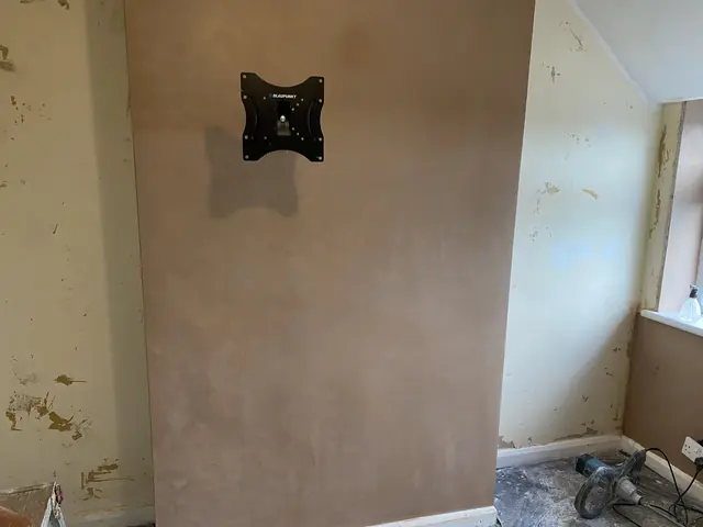 Chimney breast freshly skimmed while the side walls wait their turn