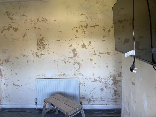 Bedroom wall before plastering, patched and uneven above the radiator