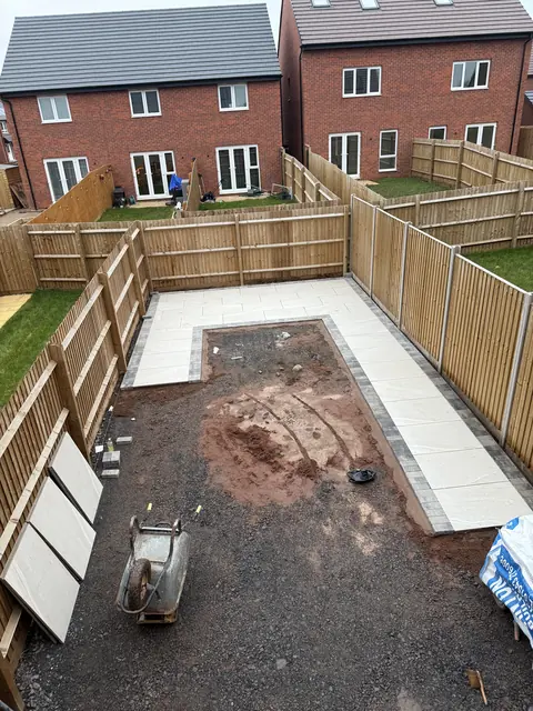 Porcelain slabs laid around the edge of the garden with a block-paved border, centre still to do