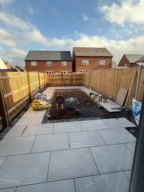 Porcelain patio finished with the centre framed in block paving, ready for the lawn